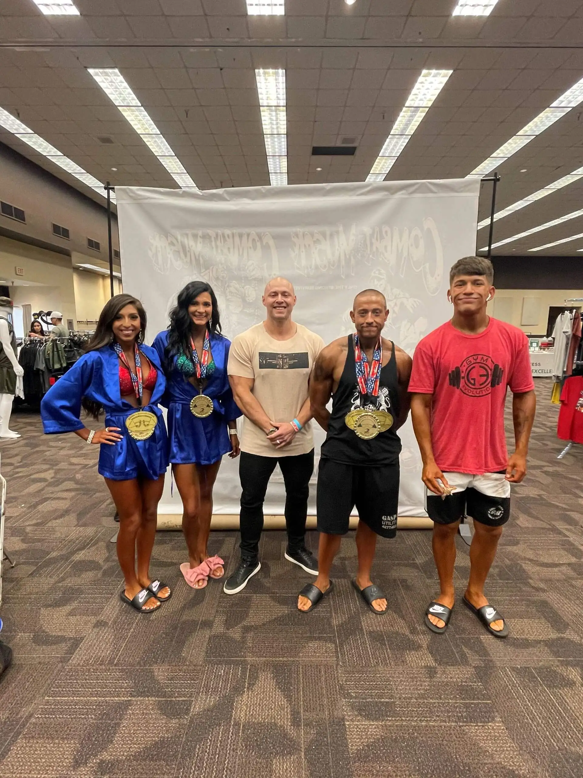 Randol Ruiz stands next to several other trainers at Gym Evolution.